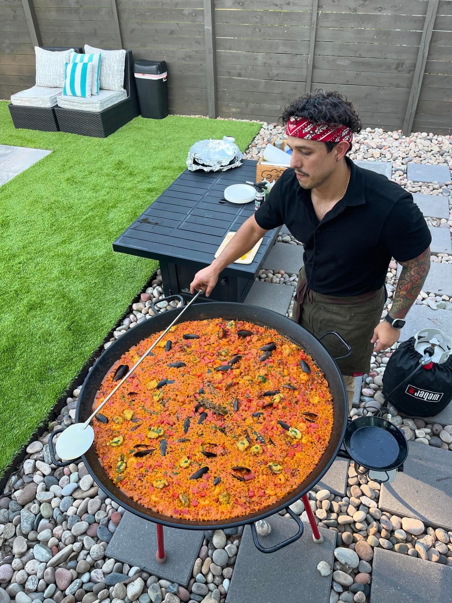 Chef Diego cooking paella in traditional pan